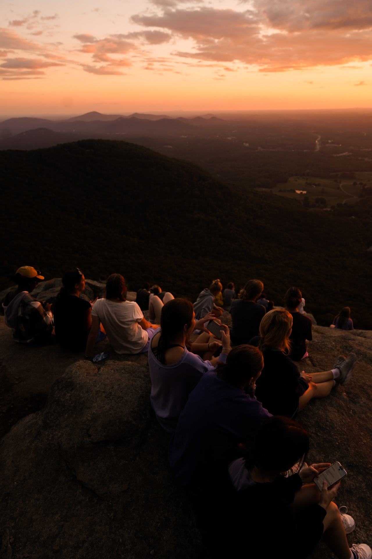 A squad watching the sunset together from a mountain overlook