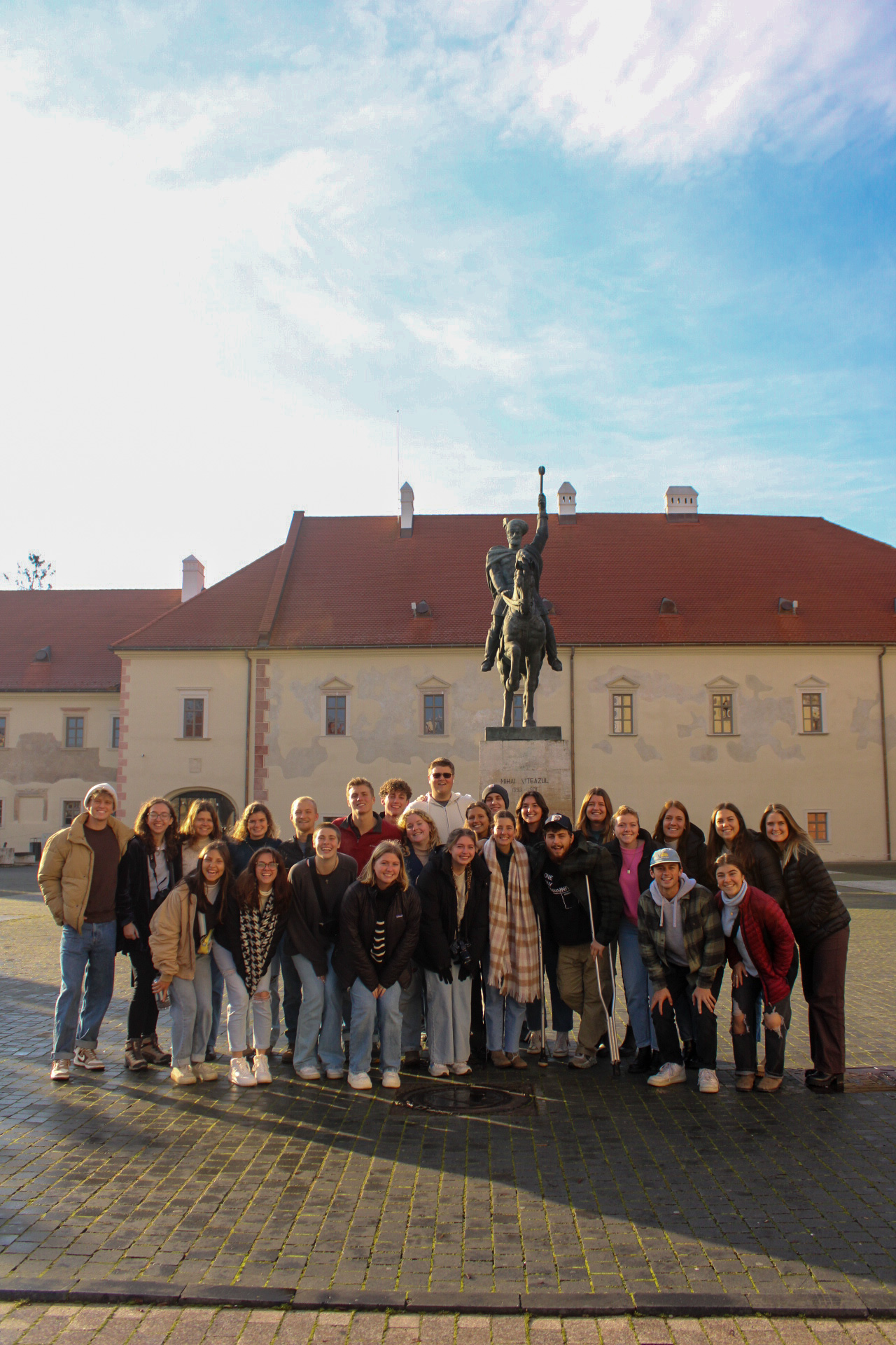 World Race group gathered in a Romanian square beneath a statue
