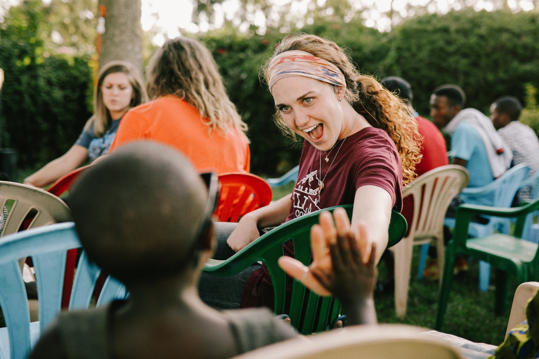 World Race participant high-fiving a child in Rwanda