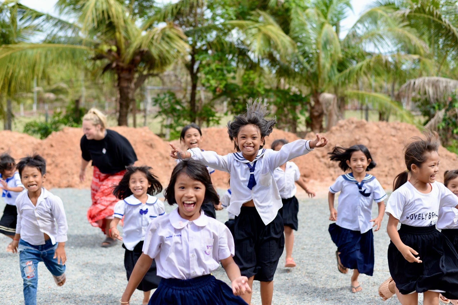 Children running toward a World Race participant in Cambodia