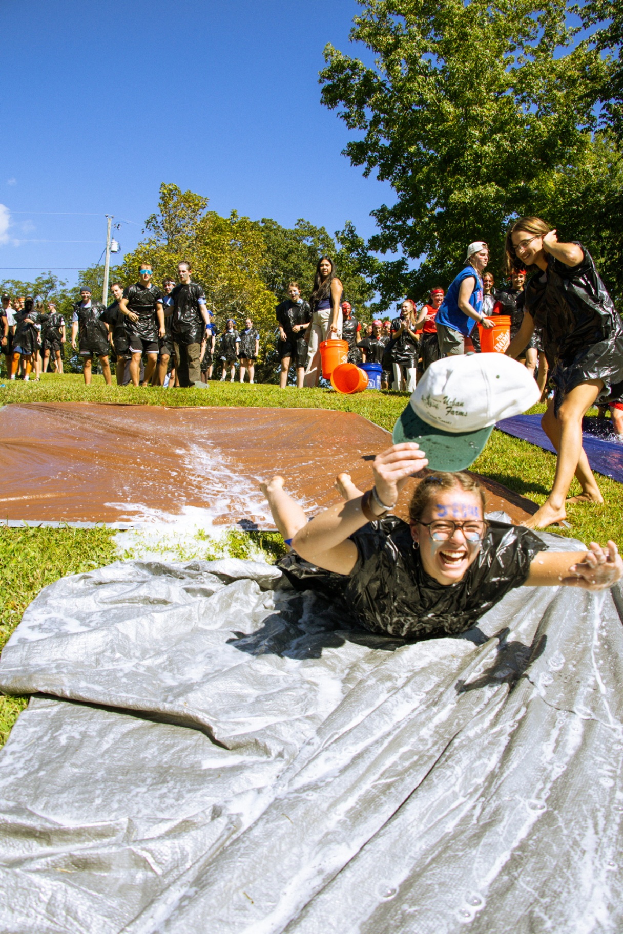 Squads mid-competition, dirt-covered and laughing, pure chaos and joy.