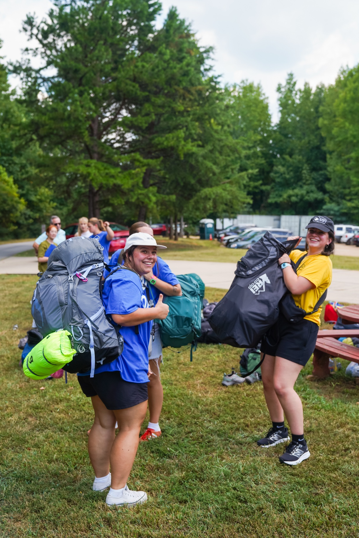 Racers arriving at training camp carrying their packs and gear