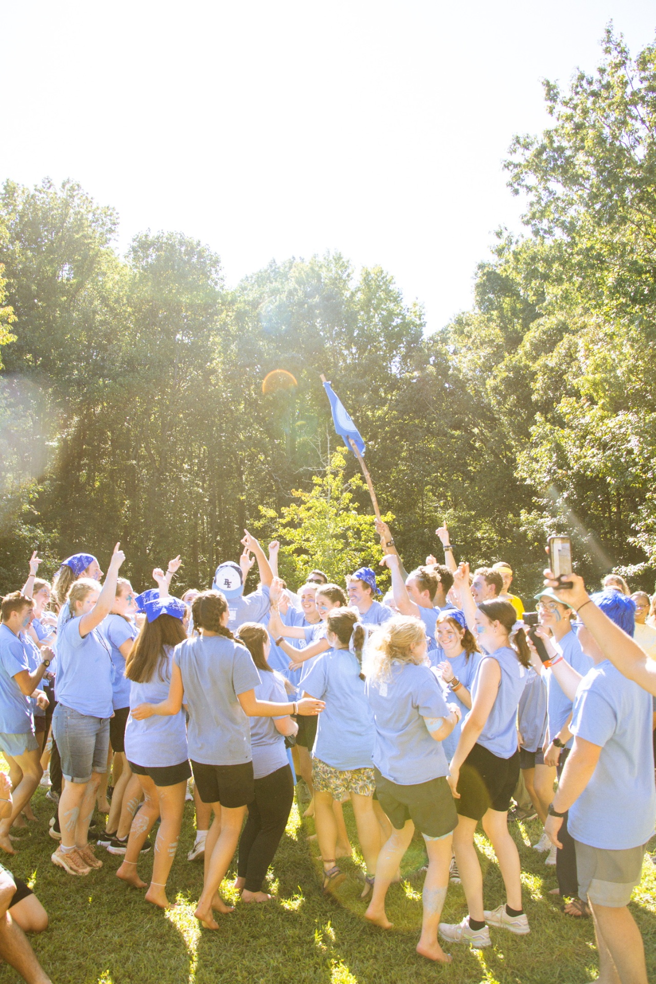 A squad cheering together outside during a team moment at training camp