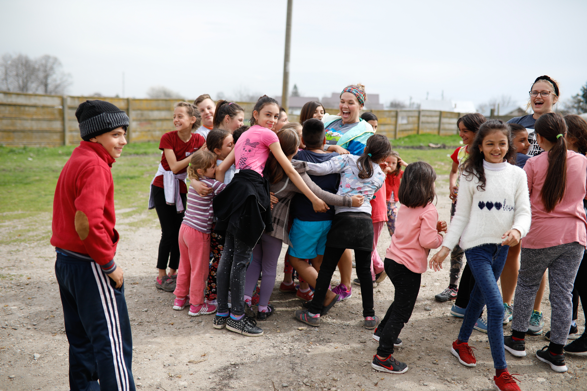 World Race participants gathered with children outdoors in Romania