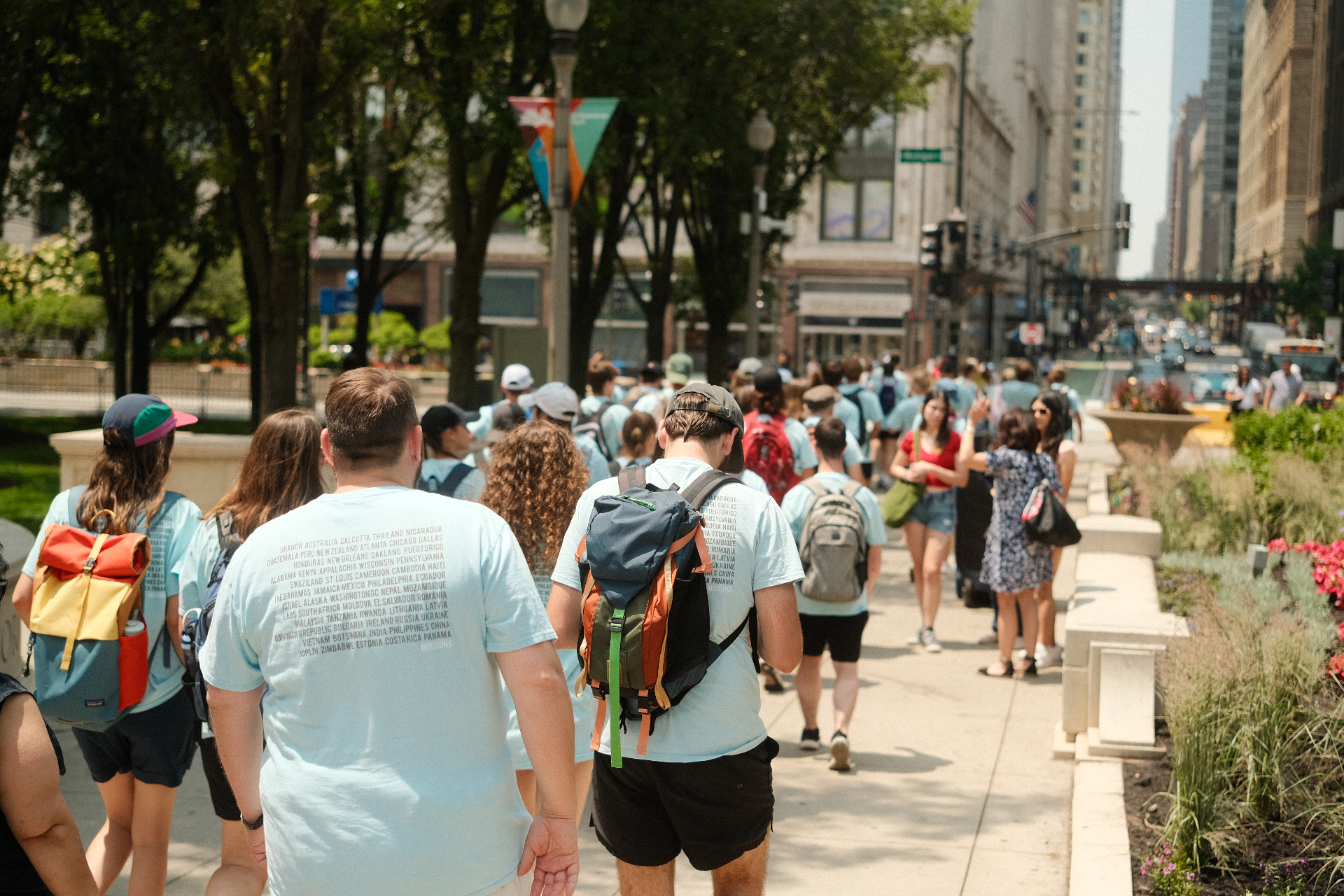 Squad walking together down a tree-lined city street