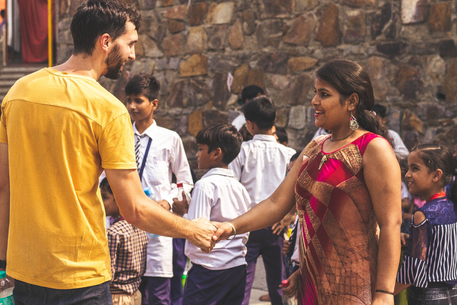 Racer greeting an Indian woman after a children program