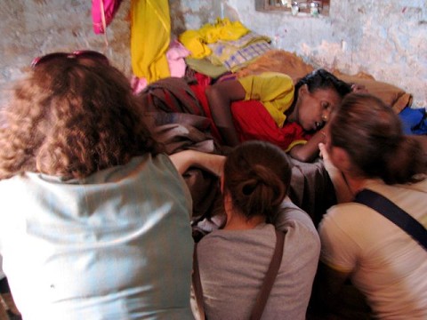 Racers praying over an Indian woman