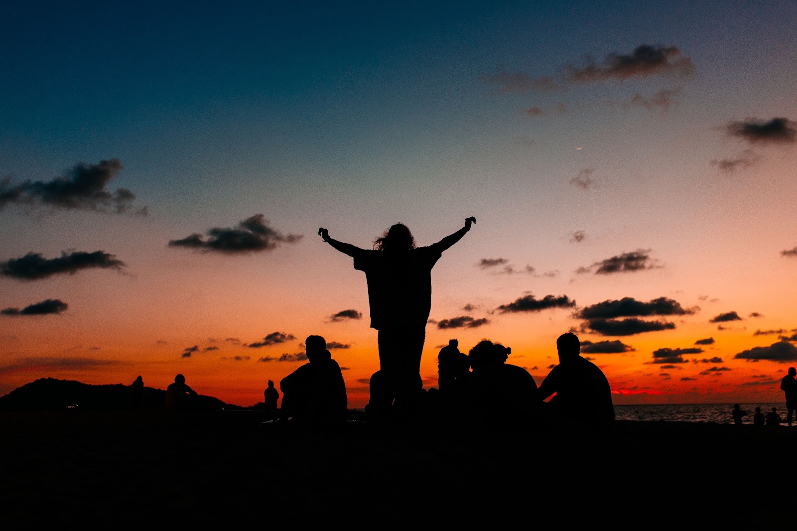 Racer worshipping with arms raised at sunset on an Indonesian beach