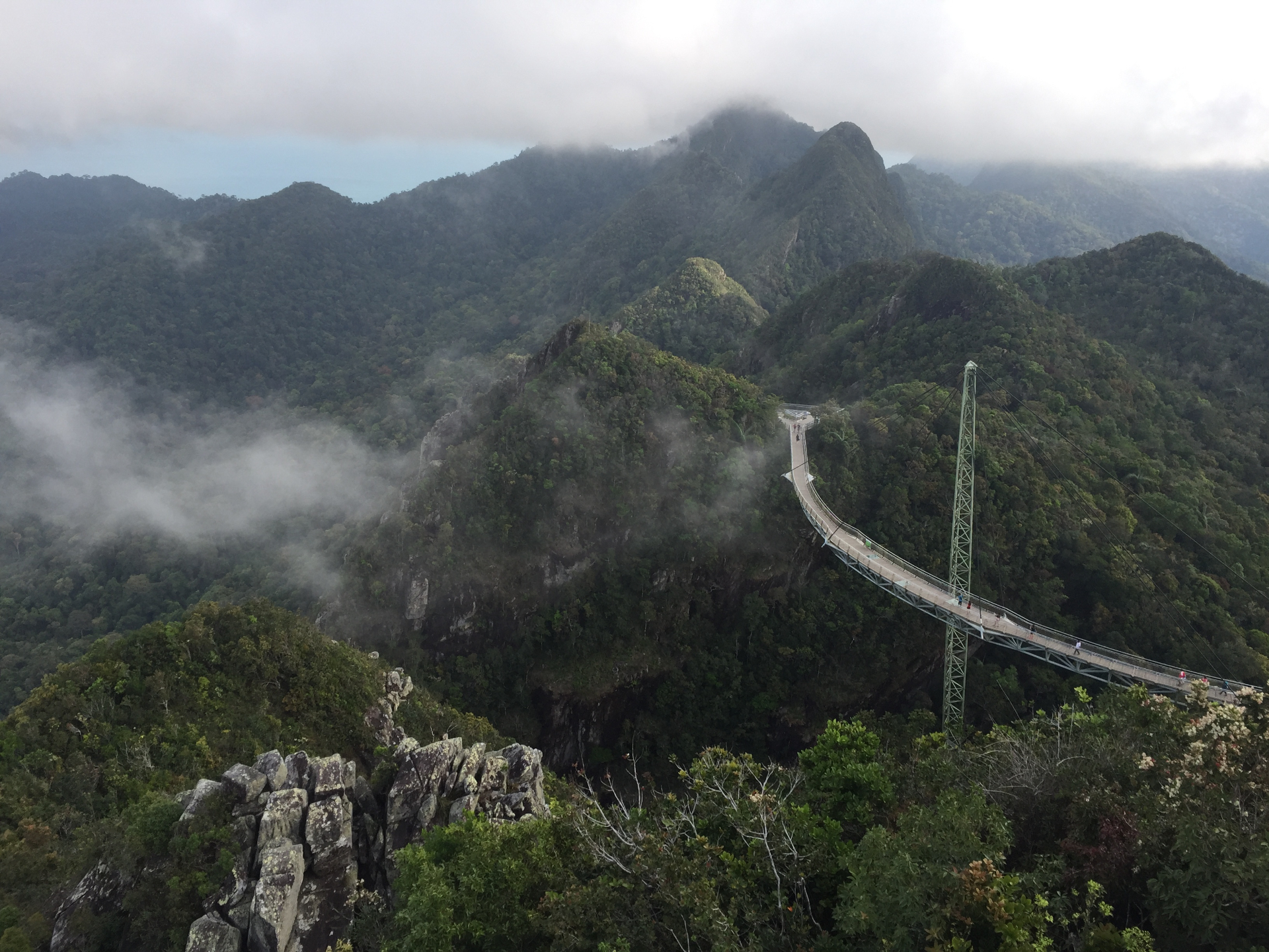 Sky bridge over misty jungle mountains in Malaysia