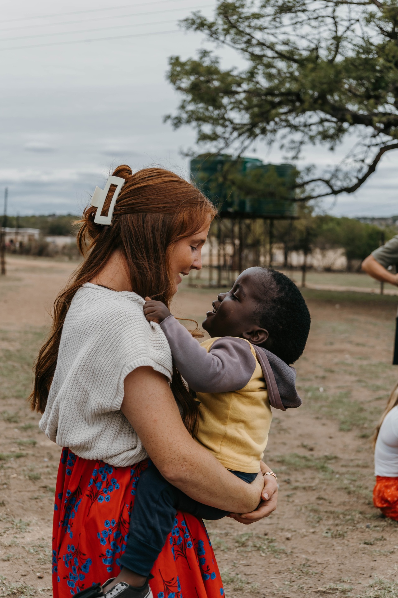 Racer holding a smiling South African child