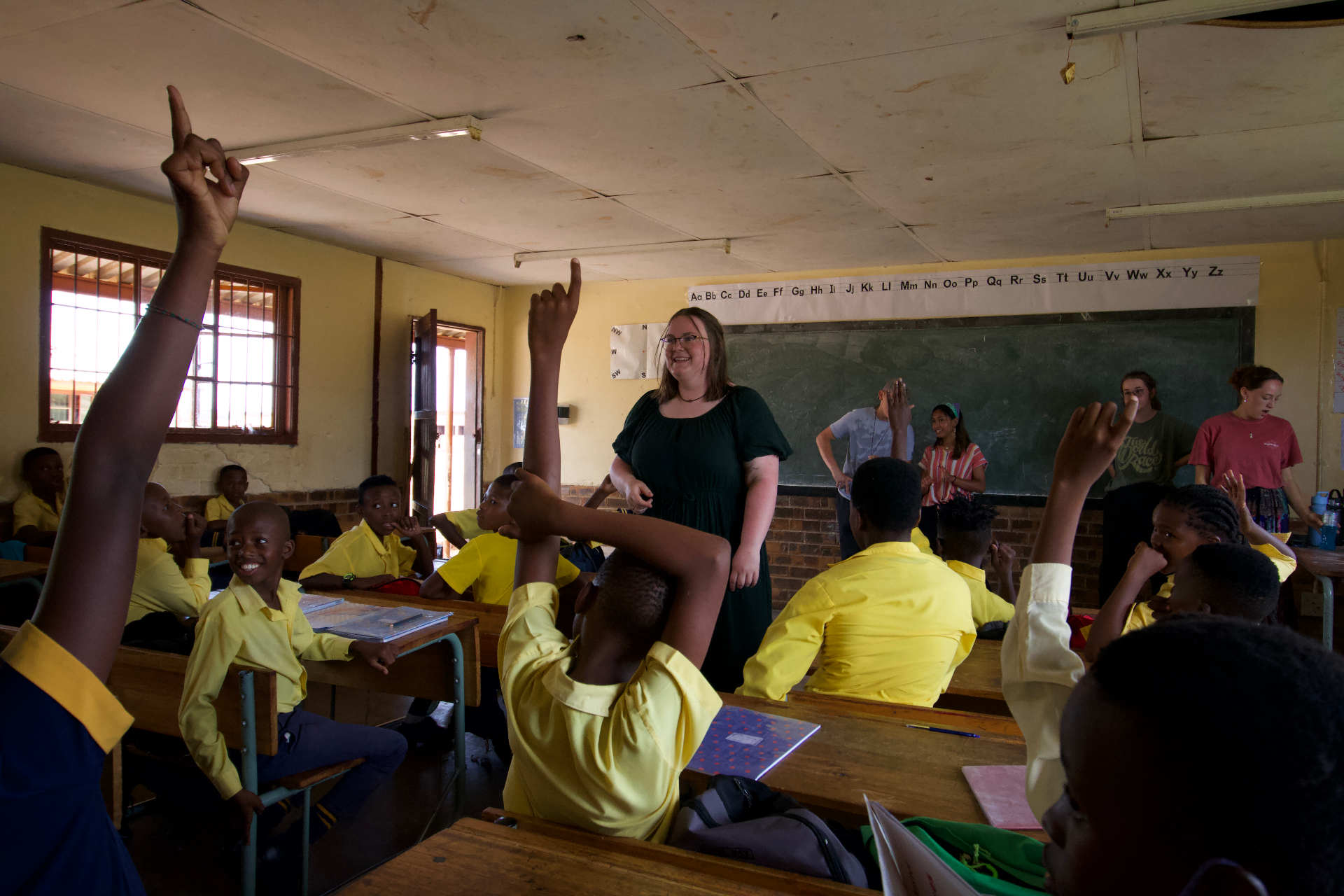 Racer teaching a South African classroom of students