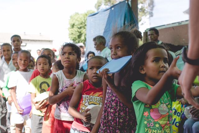 South African children waiting in line for a feeding program